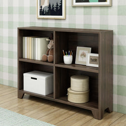 Dark wooden bookshelf with books, toys, and decorative items against plaid wallpaper in a cozy room.