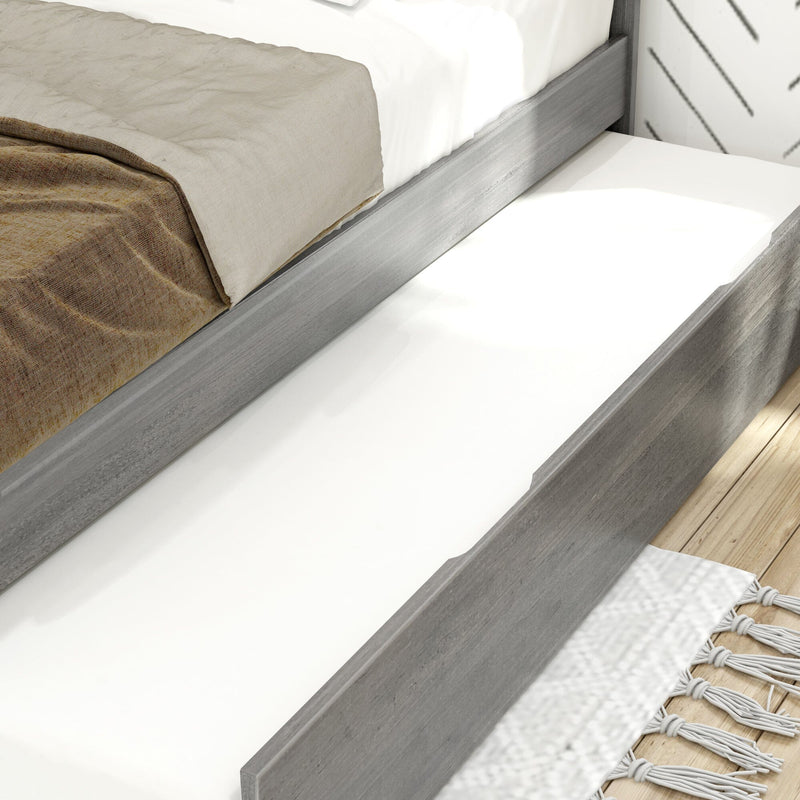 Close-up of gray wood platform bed with neutral beige and brown linen, white mattress and pull-out trundle on light hardwood floor