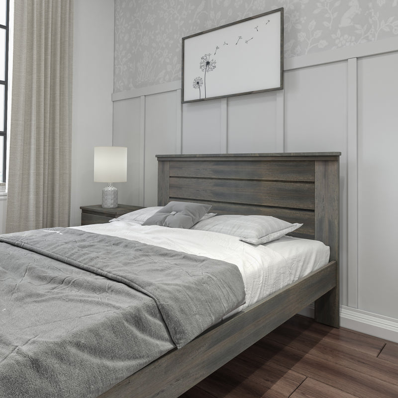 Modern farmhouse bedroom with gray wooden bed frame, neutral bedding, paneled accent wall, dandelion wall art, nightstand and lamp