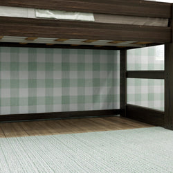 Dark wood loft bed with green checkered plaid wallpaper, stylish interior decor.