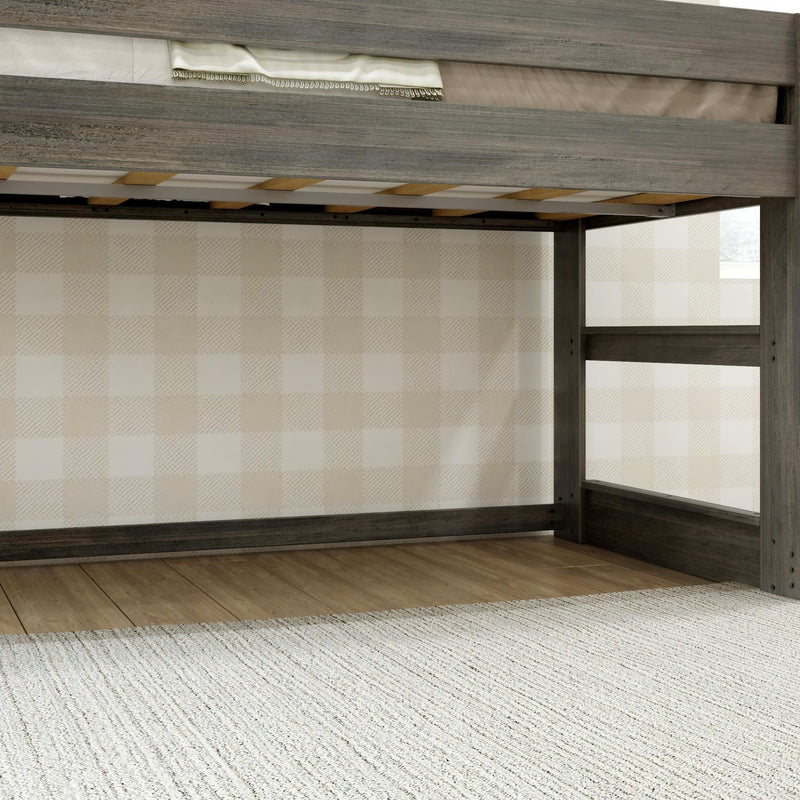 Gray wooden loft bed frame with slatted mattress support and ladder against beige buffalo-check wallpaper, hardwood floor and cream rug