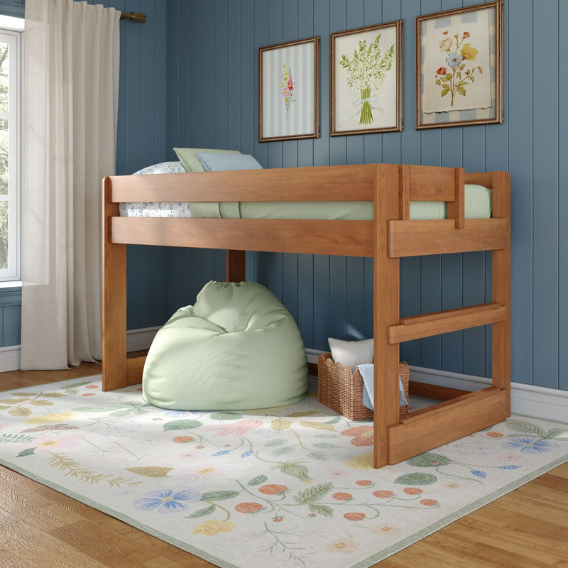 Wooden kids bunk bed against a blue paneled wall with sheer curtains, pastel floral area rug, green beanbag, wicker storage basket and framed botanical prints — cozy children's bedroom decor
