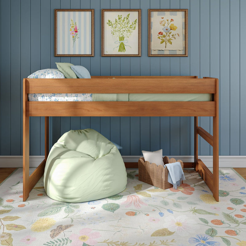 Kids bedroom with wooden loft bed, blue paneled wall, framed floral artwork, mint green bean bag and wicker basket on a pastel floral rug