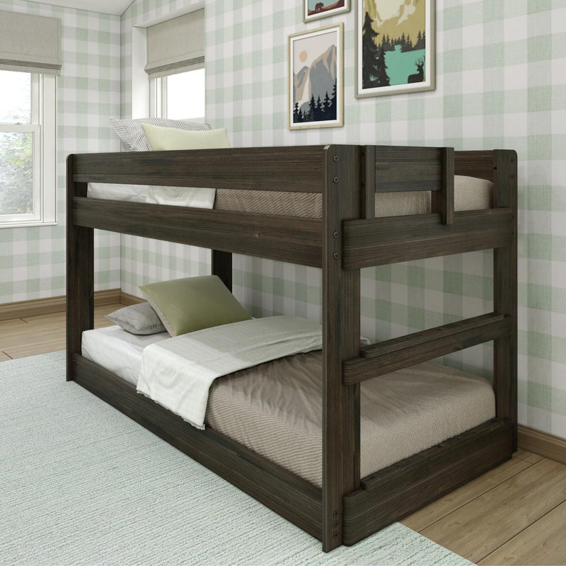 Dark wood twin bunk bed in a cozy kids' bedroom with green plaid wallpaper, neutral bedding, decorative pillows and framed mountain and forest prints