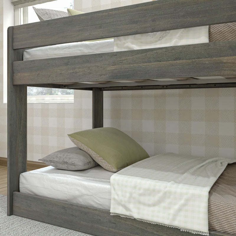 Gray rustic wood twin bunk bed frame with white and green bedding and pillows in a cozy modern farmhouse bedroom