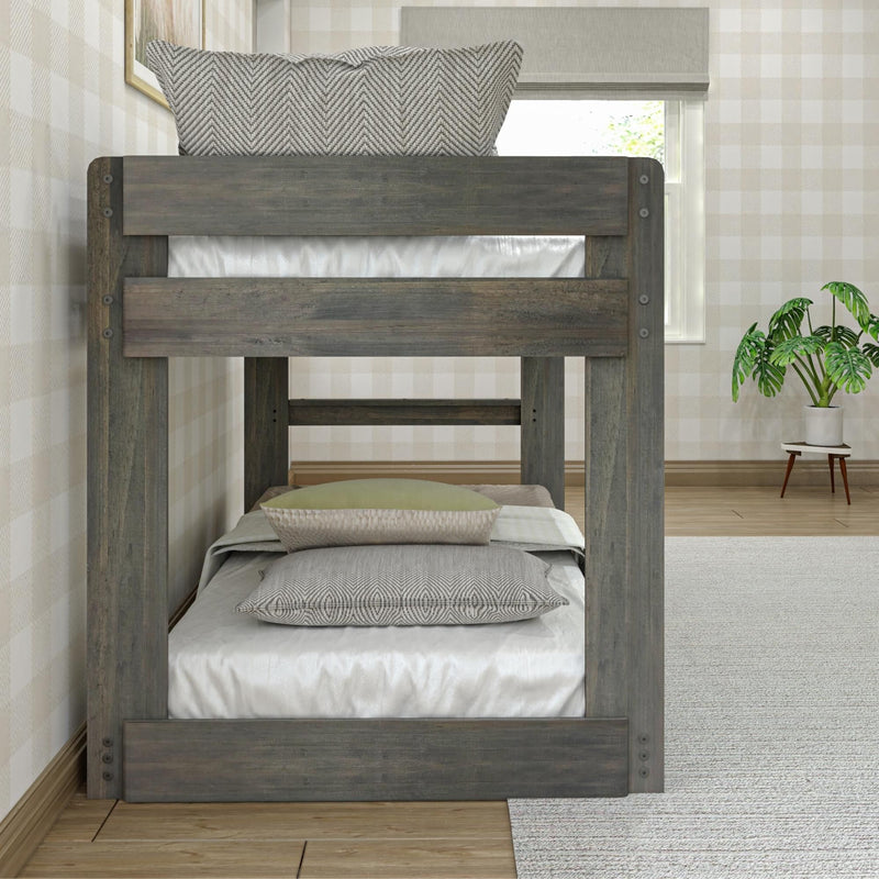 Rustic gray wooden bunk bed with chevron-pattern pillows and white bedding against neutral plaid wallpaper in a modern farmhouse bedroom with potted plant