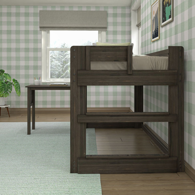 Dark wood loft bed over study desk in a bright kids' bedroom with green gingham wallpaper and window