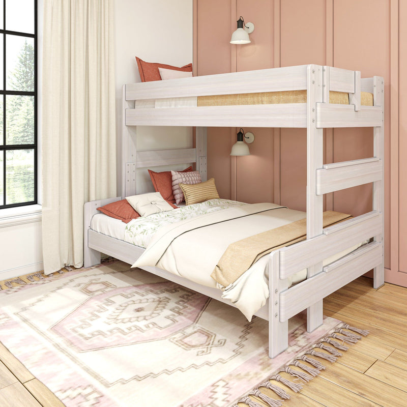 White wooden bunk bed in a boho kid’s bedroom with pink accent wall, neutral bedding, textured pillows, patterned area rug and sunlit window