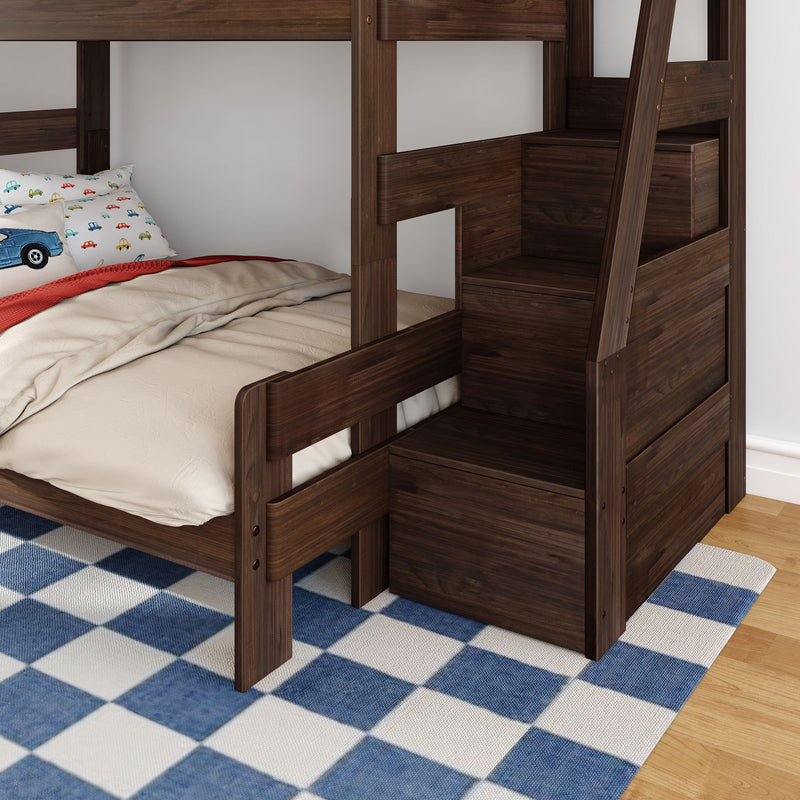 Dark walnut wooden bunk bed with built-in staircase storage drawers, twin lower bed with car-print pillow and blue check rug