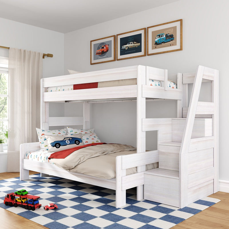 White wooden bunk bed with storage stairs in a kids' bedroom, car-themed bedding and pillows, framed vintage car prints above and toy cars on a blue checkered rug