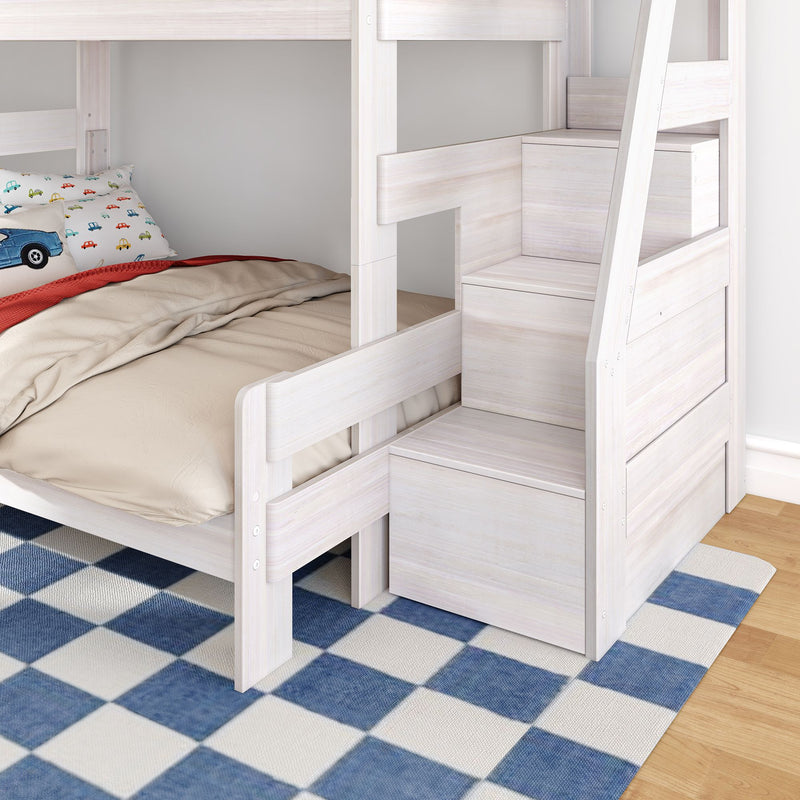 White wooden bunk bed with built-in storage stairs, beige bedding and car-print pillow in a kids' bedroom over blue checkered rug
