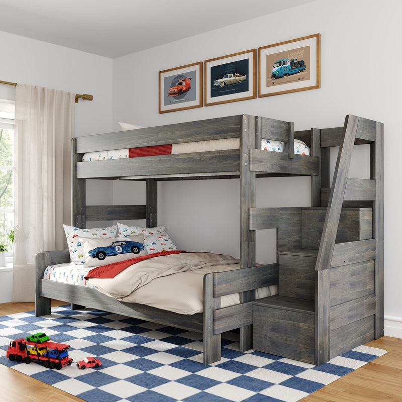Gray wooden loft bunk bed with storage stairs in kids' bedroom, car-themed bedding, framed vintage car prints and blue checkered rug