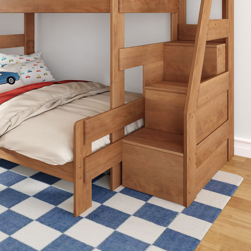 Natural wood bunk bed with built-in stair storage and lower twin mattress, car-print pillow and beige bedding on blue check rug in kids' bedroom