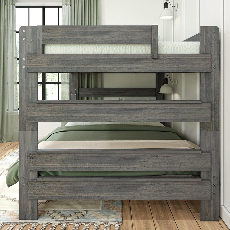 Rustic gray wooden bunk bed with green bedding and guard rails in a modern farmhouse bedroom with window, sheer curtains and wall sconce