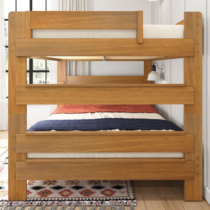 Solid wood twin-over-twin bunk bed frame in natural oak finish—sturdy slat support, neutral linen mattress with navy and rust bedding, modern farmhouse space-saving design for kids' bedroom with patterned rug and wall sconce.