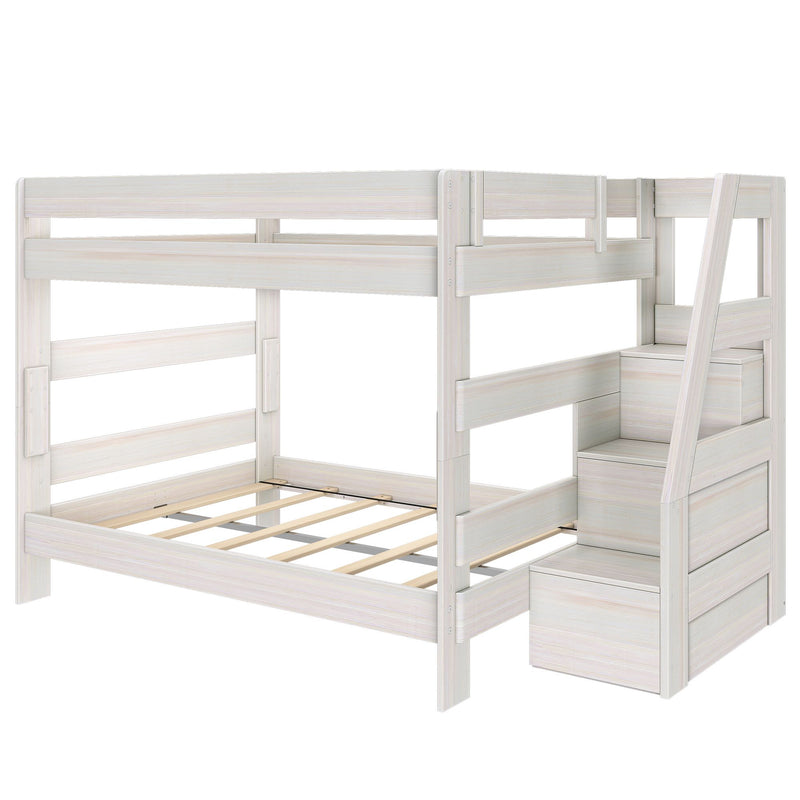 Whitewashed wooden twin-over-full bunk bed frame with safety rails, slatted mattress supports and staircase with built-in storage drawers