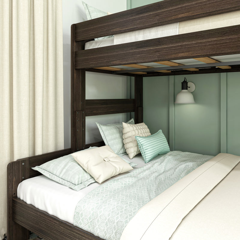 Dark wood bunk bed close-up with mint green bedding, decorative pillows, wall sconce and cream curtains