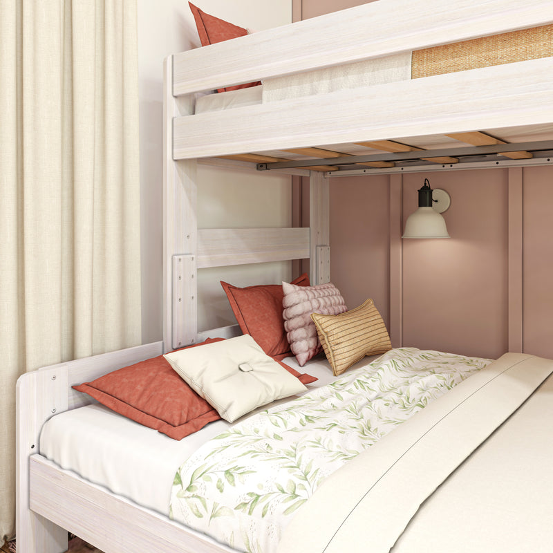 Whitewashed wooden bunk bed with coral and cream pillows, floral duvet, wall-mounted reading lamp and beige curtains in a cozy bedroom nook