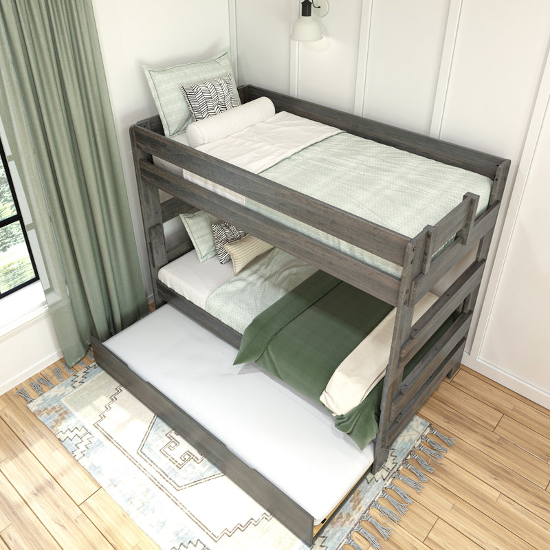 Wooden twin-over-twin bunk bed with green and white bedding, patterned pillows and guardrails in a modern farmhouse kids' bedroom
