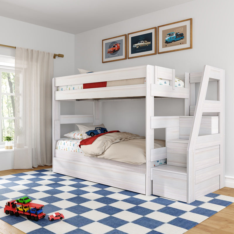 Whitewashed wooden loft bunk bed with storage stairs and car-themed bedding over blue checkered rug, toy cars and framed car prints in a kids' bedroom