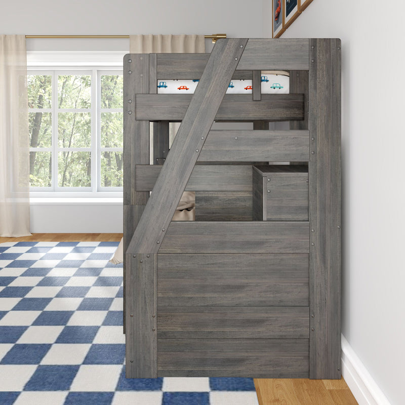 Grey wooden loft bunk bed with built-in storage, car-print bedding, blue checkered rug and window with sheer curtains in a kids' bedroom