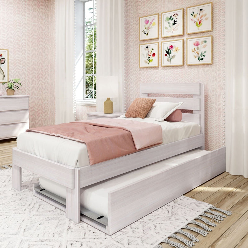 Cozy modern pink and white girl's bedroom with white wooden twin bed and pull-out trundle, blush bedding, floral framed wall art, white curtains and light wood floors