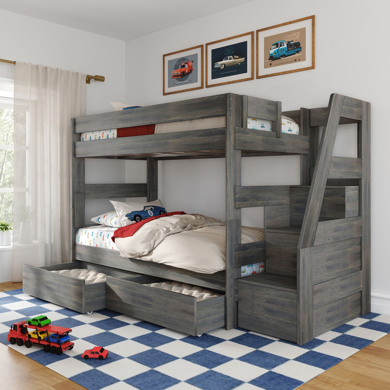 Gray wooden bunk bed with built‑in storage drawers and trundle bed in a children's bedroom with car-themed bedding, framed car prints, blue checkered rug and toy cars