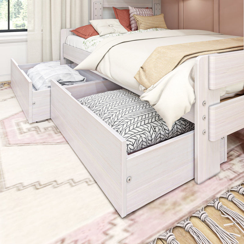White wood platform bed with open under-bed storage drawers holding folded linens and decorative pillows in a cozy modern bedroom — space-saving storage solution