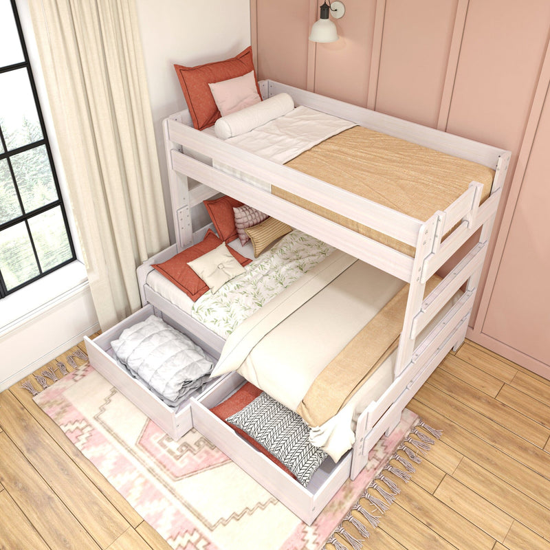 White wooden twin-over-full bunk bed with built-in storage drawers, neutral and coral bedding, ladder and rug in a modern pink-accent kids bedroom