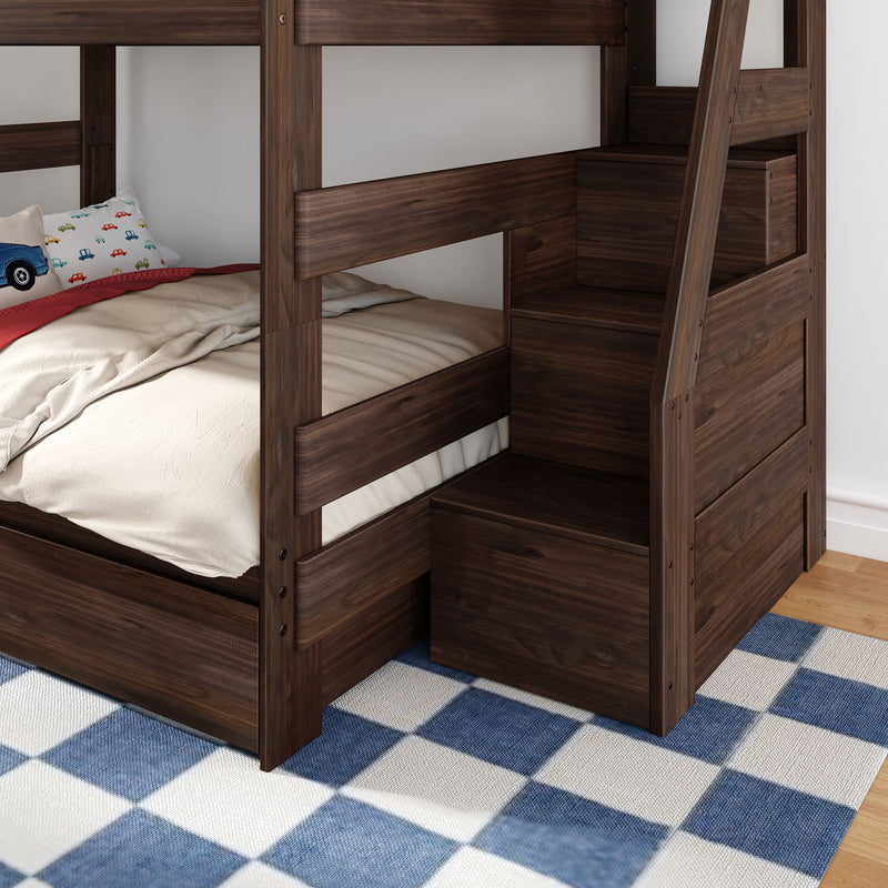 Dark walnut wooden bunk bed with built-in staircase storage, beige bedding, car-print pillow and blue plaid rug in a kids' bedroom