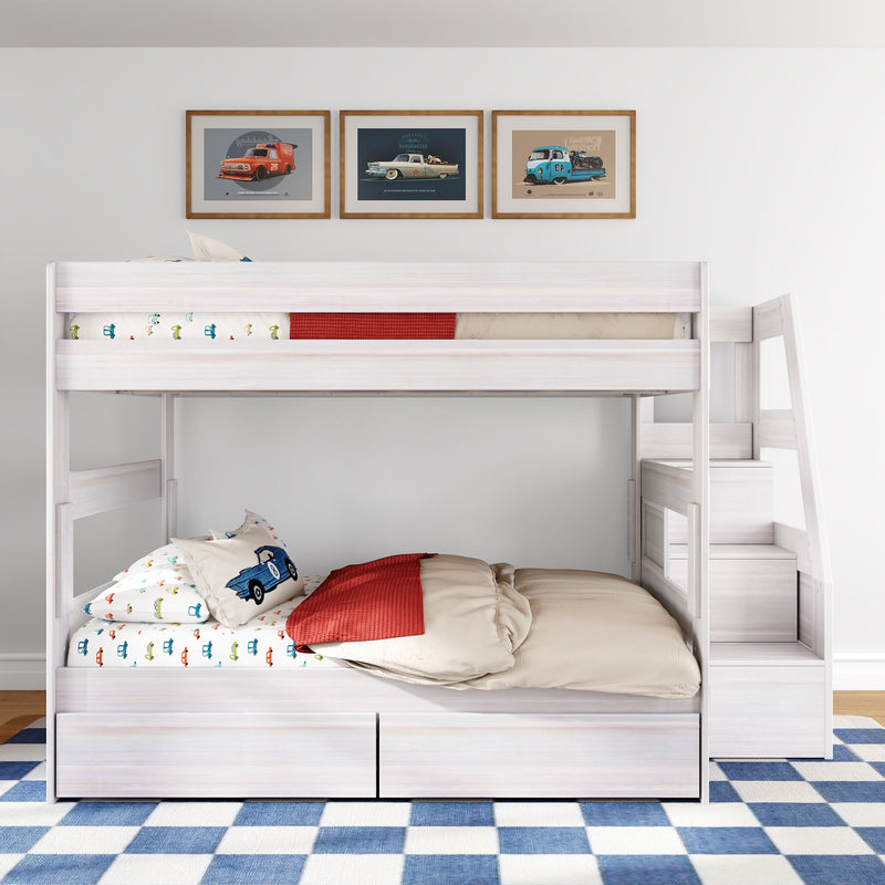 White wooden twin-over-full bunk bed with staircase and storage drawers, car-themed bedding and framed car prints in kids' room