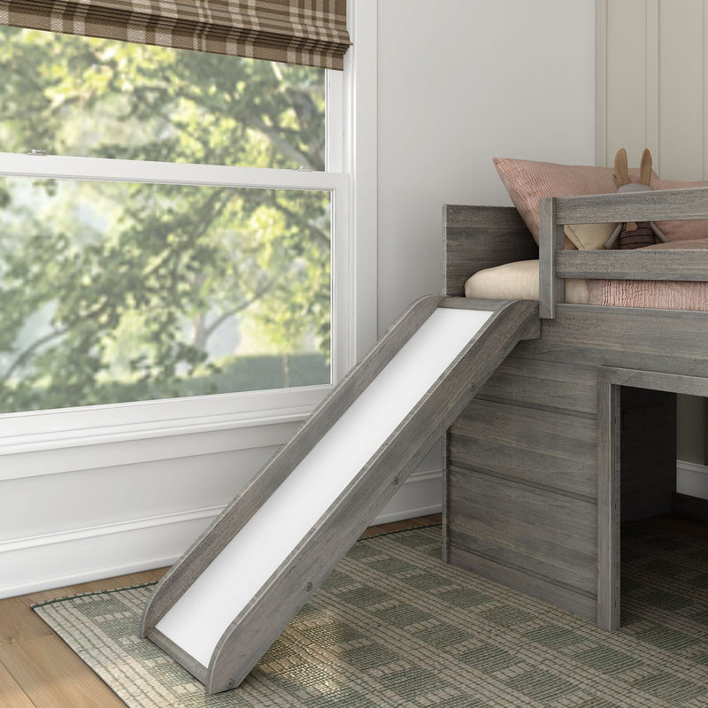 Grey wooden loft bed with slide, pink bedding and stuffed bunny beside a large window in a modern kids' bedroom