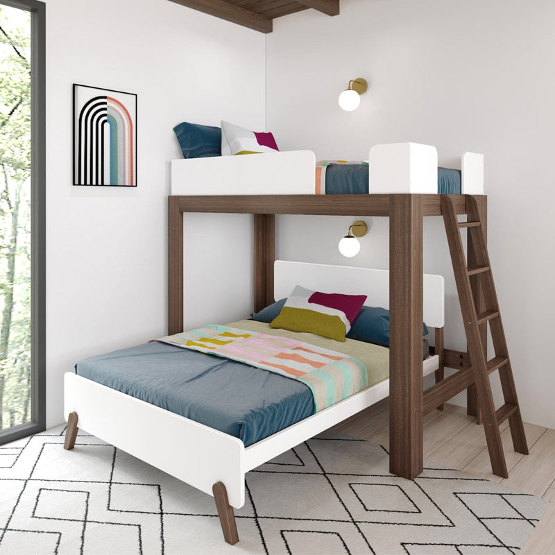 Modern wooden bunk bed with white guardrails and ladder in bright kids' room, colorful bedding, wall sconce and abstract art.