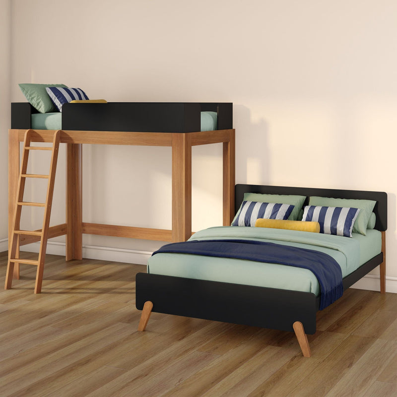 Modern wooden loft bunk bed with ladder and black guardrail, twin lower bed with teal bedding, striped pillows and yellow accent cushion on hardwood floor