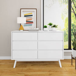 Mid-century modern white dresser in bright room with plants and abstract art.