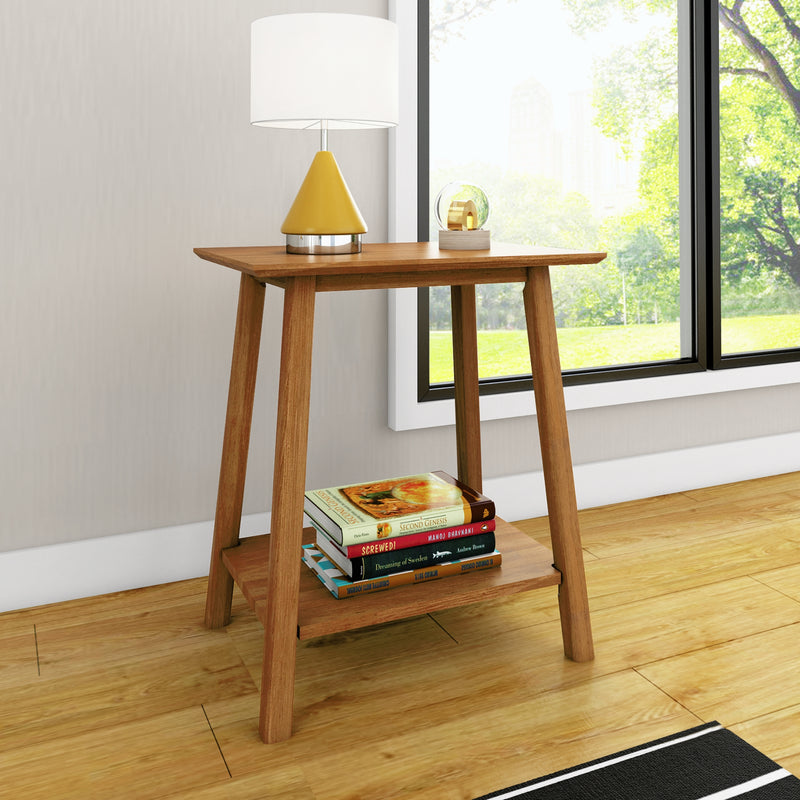Modern wooden side table with a yellow cone table lamp and stacked books beside a large window overlooking a sunlit green park, minimalist living room decor