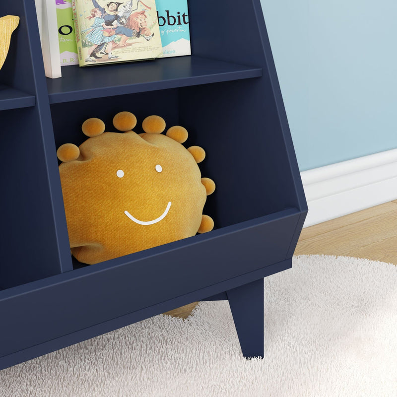 Modern navy-blue children's bookshelf with smiling sun plush pillow and classic children's books in a cozy nursery reading nook