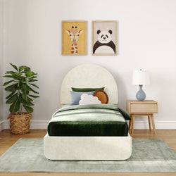 Children's bedroom with cozy bed, animal art, potted plant, and modern decor.