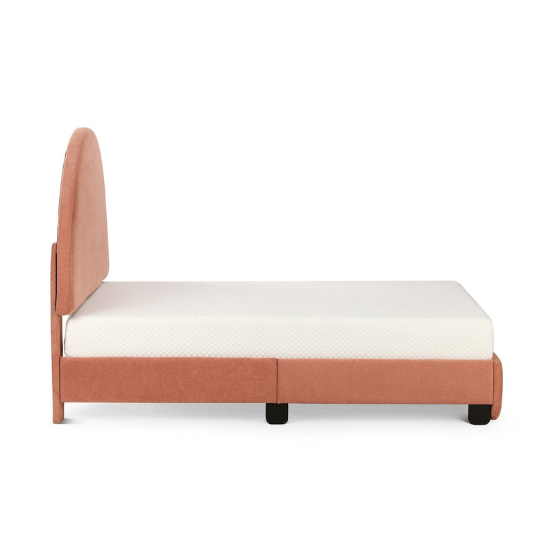 Side view of coral upholstered platform bed with rounded fabric headboard, white mattress and black legs