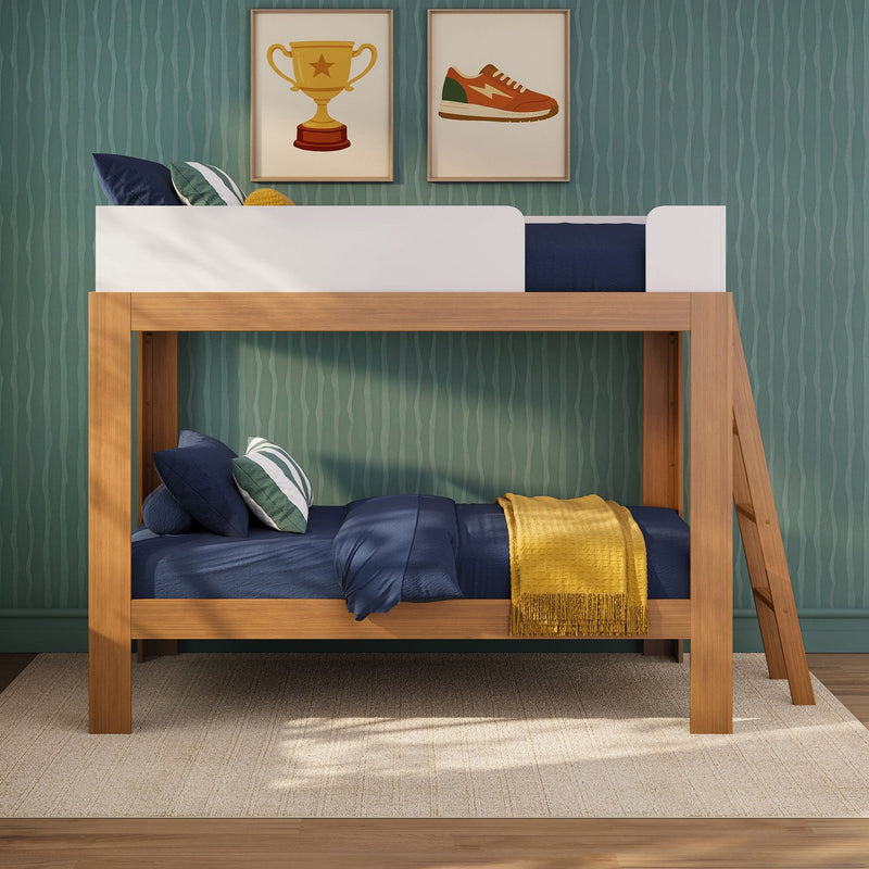 Wooden loft bunk bed in modern kids' bedroom with navy bedding, striped pillows, yellow throw and framed trophy and sneaker prints on green textured wallpaper