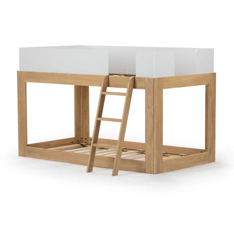 Children's wooden loft bed with ladder and white guardrails.