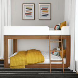 Stylish wooden bunk bed with mustard yellow bedding and decorative pillows in modern bedroom.