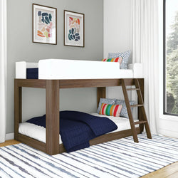 Modern wooden bunk bed with navy blue bedding and colorful pillows in a stylish bedroom.