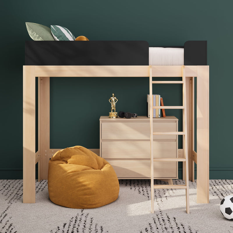Wooden loft bed with ladder and black guardrail above dresser, mustard bean bag, books and soccer ball in a modern kids' bedroom with dark green wall