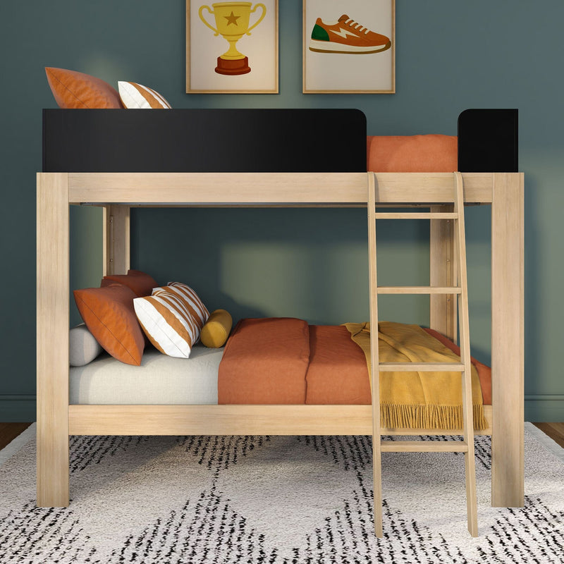 Modern wooden loft bunk bed with ladder and black safety rail, orange duvet and striped pillows in a kids' bedroom with green wall and framed art