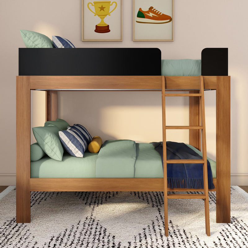 Wooden loft bunk bed with ladder, black guardrail and mint-green bedding in kids' bedroom with striped pillows, navy throw and framed trophy and sneaker prints