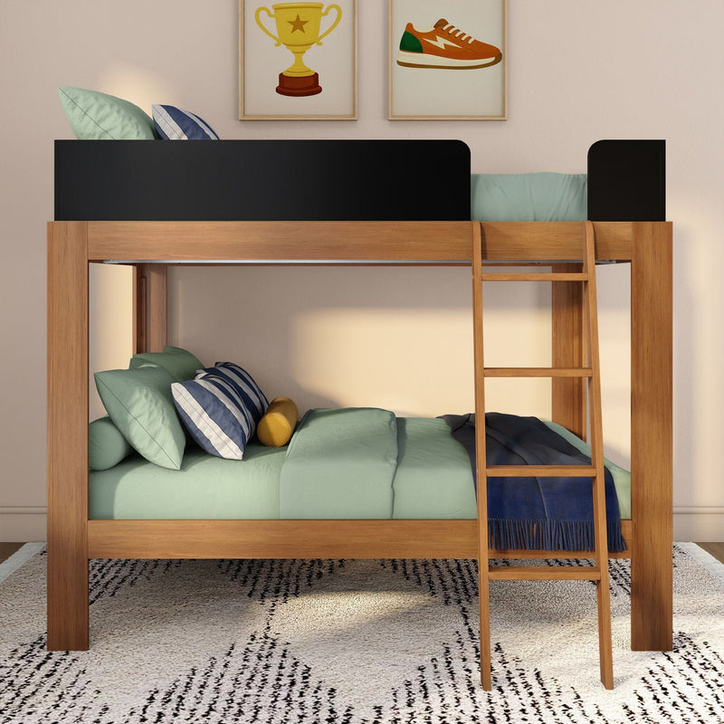 Wooden loft bunk bed with ladder, black guardrail and mint-green bedding in kids' bedroom with striped pillows, navy throw and framed trophy and sneaker prints