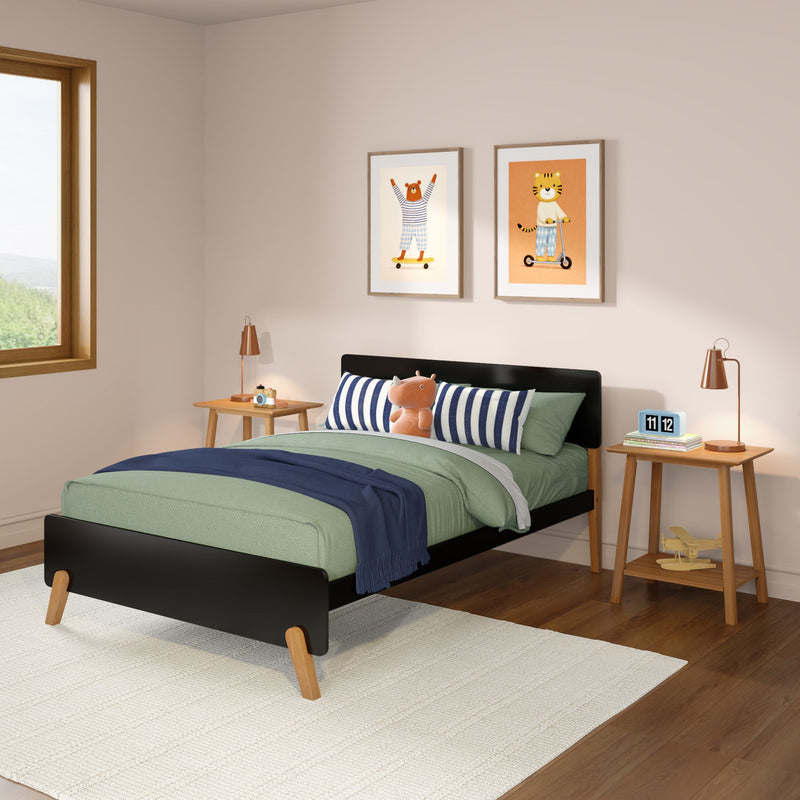 Modern mid-century kids' bedroom with black wooden bed, green bedding, navy throw, striped pillow, plush hippo toy, wooden nightstands and copper lamps