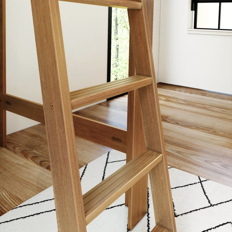Close-up of a wooden ladder with slatted steps on a hardwood floor beside a white geometric rug in a modern minimalist interior