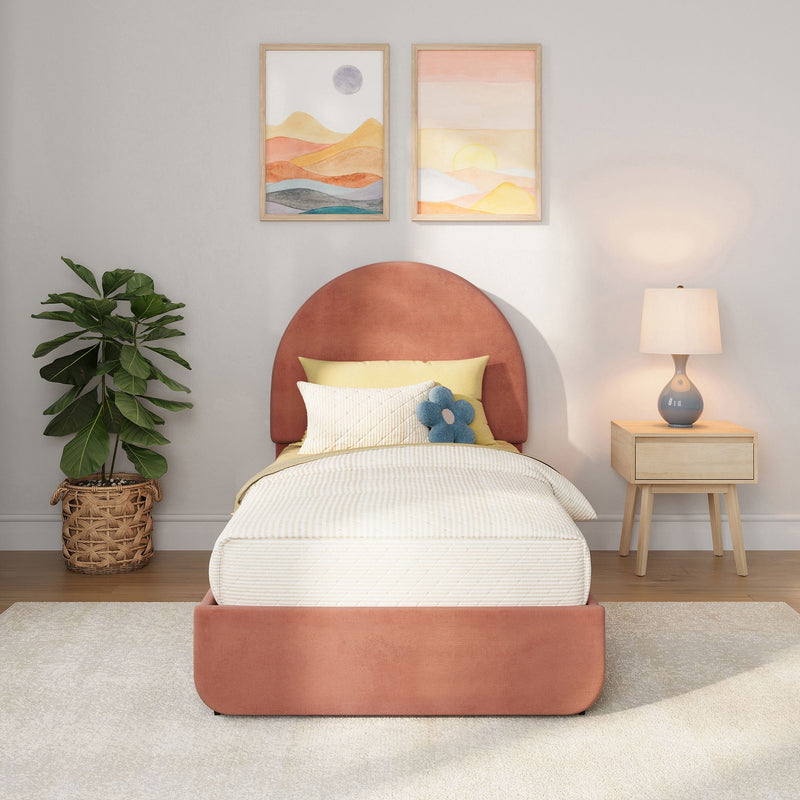Modern cozy bedroom with coral upholstered headboard, neutral striped bedding, potted fiddle leaf fig, wooden nightstand with blue ceramic lamp and abstract framed wall art